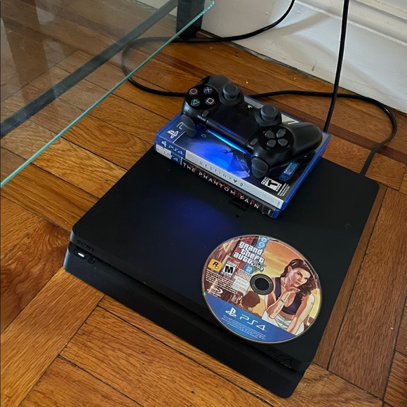 PS4 Slim 1TB With 6 Games And one Controller. Black color. Been used before. - Picture 3 of 4